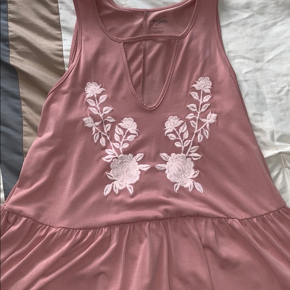 Sleeveless light pink top.